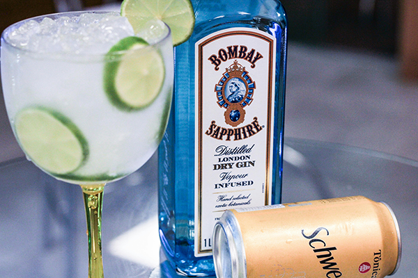 Cocktail Gin tonic avec bouteille de Bombay Sapphire et une canette de Schweppes